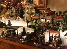 a christmas village is displayed on a table