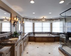 a large bathroom with marble counter tops and double sinks