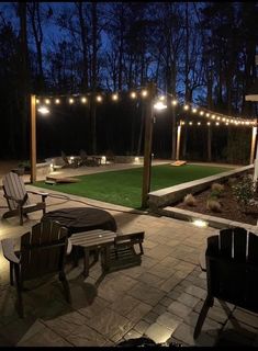 an outdoor patio with string lights and lawn furniture