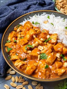 a close up of a plate of food with rice and nuts on the table next to it