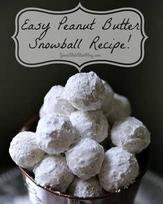 a bowl filled with snowball cookies on top of a table