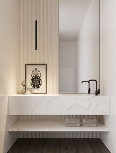 a bathroom with a marble counter top and white walls, along with wooden flooring