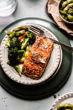 a plate with salmon, broccoli and asparagus on it that says miso glazed salmon easy sheet pan dinner