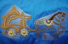 two horse drawn carriages made out of gold and crystal beads on a blue fabric background