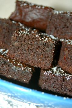 chocolate brownies with powdered sugar in a blue bowl