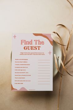 a pink and orange printable find the guest card next to a white bowl filled with dried grass