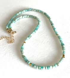 "Peruvian blue opal beaded choker with tiny gold vermeil accents and gold fill clasp.  Gorgeous earth mined natural  faceted 3.5mm Peruvian blue opal rondelles in  shades of aqua blue. 2mm faceted 24k gold vermeil spacers add sparkle.  Dainty gemstone necklace is 15 1/2\" with 2\" extension. Spring ring clasp and findings are 14k gold fill. Also available in .925 sterling silver.  Matching Peruvian blue opal bracelet available separately in shop: https://linettesjewelrychest.etsy.com/listing/153 Gold Single Strand Turquoise Necklace For Gift, Gold Opal Round Beads Necklace, Gold Opal Necklace With Round Beads, Gold Opal Jewelry With Round Beads, Gold Rondelle Hand-strung Necklaces, Adjustable Gold Single Strand Turquoise Necklace, Gold Single Strand Amazonite Beaded Necklace, Gold Single Strand Beaded Necklace With Amazonite, Bohemian Single Strand Turquoise Necklace In Gold