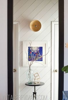 an entry way with a table and vase on it