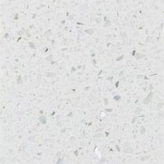 a white counter top with small pieces of glass on it