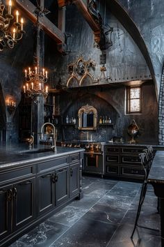 an ornate kitchen with black cabinets and chandeliers