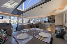 a dining table with place settings on it in a room that looks like a boat