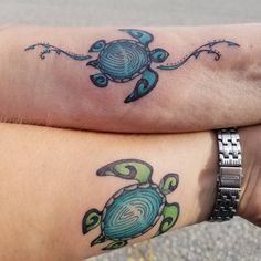 two people with matching tattoos on their arms, one has a green turtle and the other is a blue sea turtle