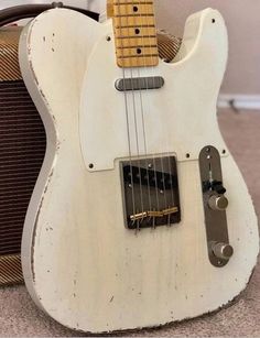 an electric guitar sitting on the ground next to a amp