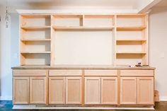 an empty room with wooden cabinets and white walls