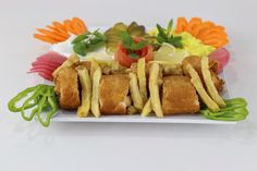 a white plate topped with french fries and vegetables