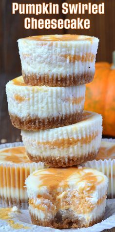 three desserts stacked on top of each other with frosting and pumpkins in the background