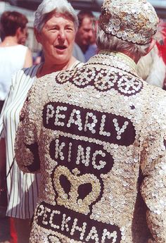 an older woman wearing a sequin jacket with the words pearly king on it