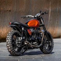 a red and black motorcycle parked on the street