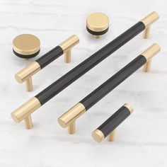 an assortment of black and gold knobs and handles