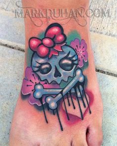 a foot with a skull and bow on it