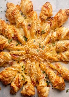 an overhead view of some breads with sesame seeds and cheese sprinkled on them