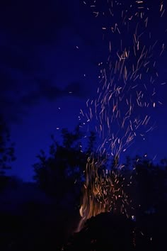 the fire is lit up at night with lots of sparklers coming out of it