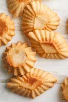 several small pastries on a white surface