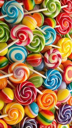 many colorful lollipops are stacked on top of each other