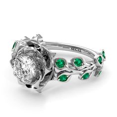 One of our favorite statement engagement rings, this exquisite design features 17 scintillating stones and story-telling enchantment. Sprouting jewel-set leaves climbing both sides of a slender band and a brilliant-cut stone, this treasured piece was modeled off Grecian laurel wreaths. Our decadent take on the historic prize makes it a dream-come-true ring that always catches someone's impressed eye. Stock Number: SA121559 Metal Setting Metal Type: 14K White Gold Main Stone Type: Natural Conflic