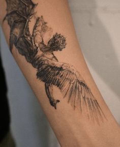 a tattoo on the arm of a woman with a bird and flowers in her hand