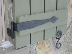 a green door with a black handle on it