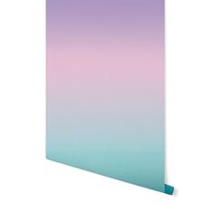 a blue and pink ombreed wall hanging on the side of a white wall