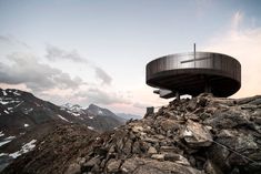 a round building on top of a rocky mountain