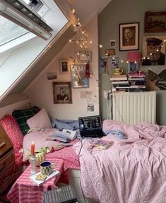 a bed room with a laptop on top of it next to a desk and window