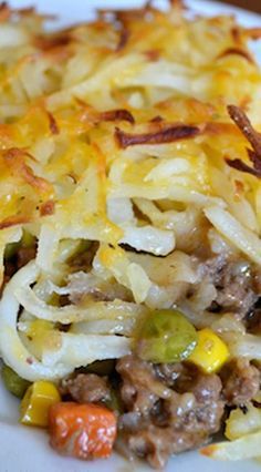 a close up of a plate of food with cheese and vegetables on it's side