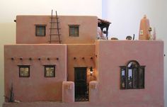 a pink house with windows and lights on the roof