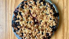 a blueberry crumb pie on a wooden table