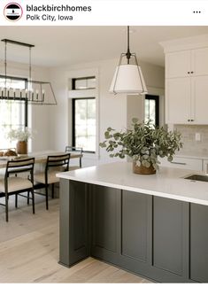 a large kitchen with white cabinets and gray counter tops is featured in the blackbird homes website