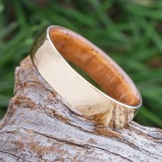 a wooden ring sitting on top of a piece of wood