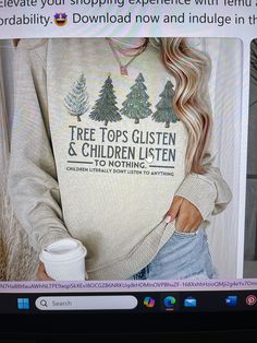 the woman is wearing a sweater that says tree tops glisten and children listen to nothing