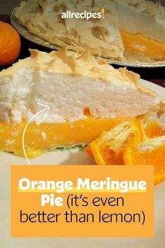 an orange meringue pie on a white plate next to some sliced oranges