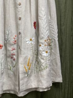 an embroidered jacket with flowers and leaves on it