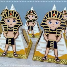 three egyptian themed bookends are shown on a table