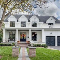 a large white house with black doors and windows