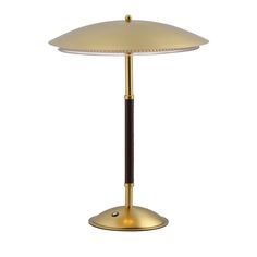 a lamp that is on top of a white tablecloth with a black and gold base