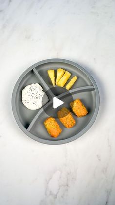 a plate with some food in it on top of a white table and a marble countertop