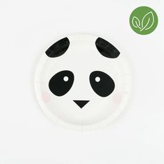 a paper plate with a black and white panda face on it's side, against a white background