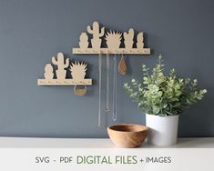 a white table topped with two wooden shelves filled with plants and hanging utensils