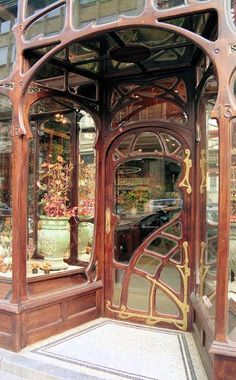 an ornate wooden entrance to a flower shop