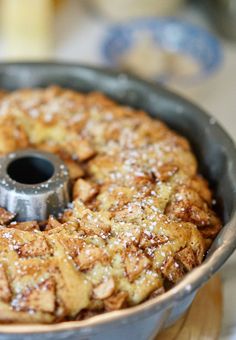 a cake in a pan with powdered sugar on top